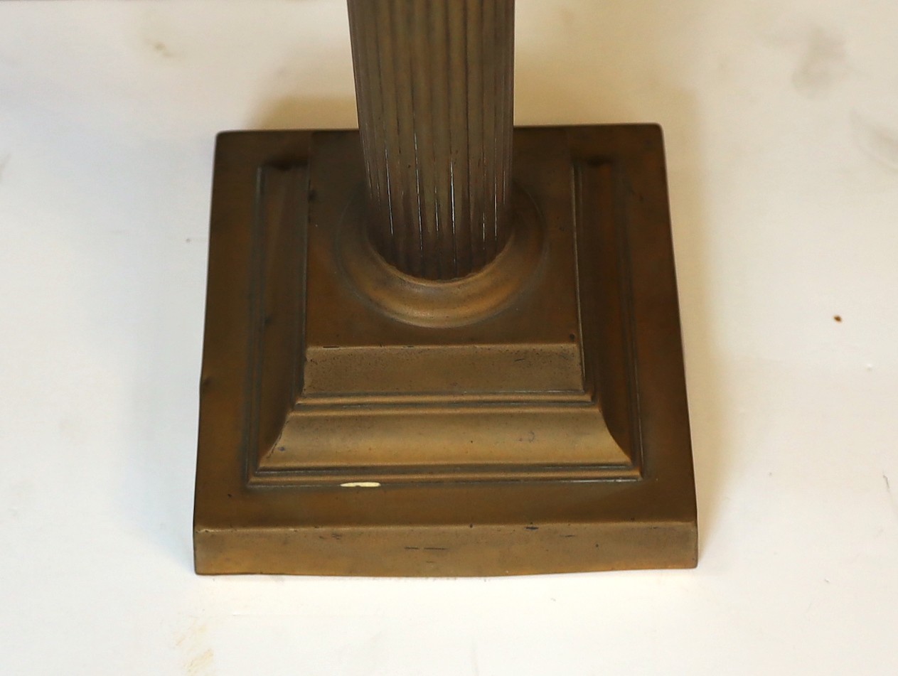 An Edwardian brass Corinthian column oil lamp with cut glass reservoir, Castle Brand mechanism and etched glass shade, height overall 86cm.